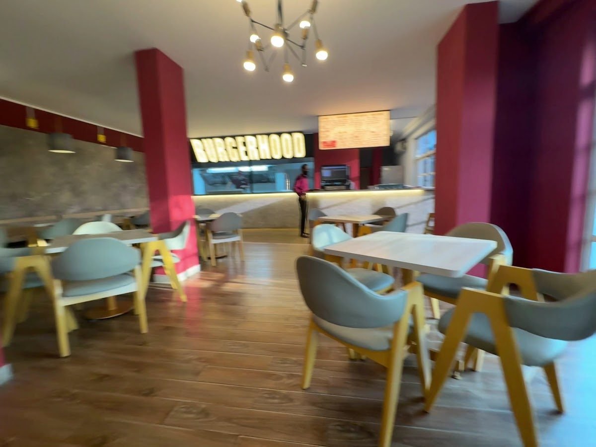 Inside Burgerhood: red pillars, cream chairs and the counter