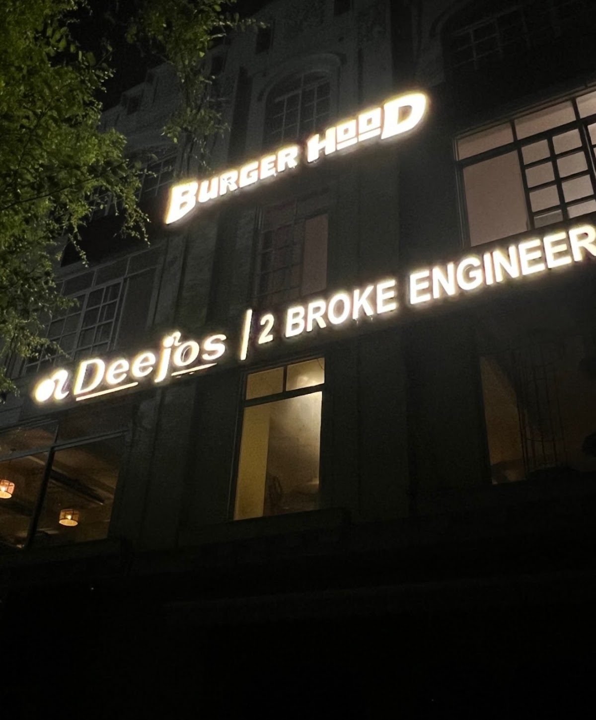 The Burgerhood sign lit up at night in F-7 Markaz